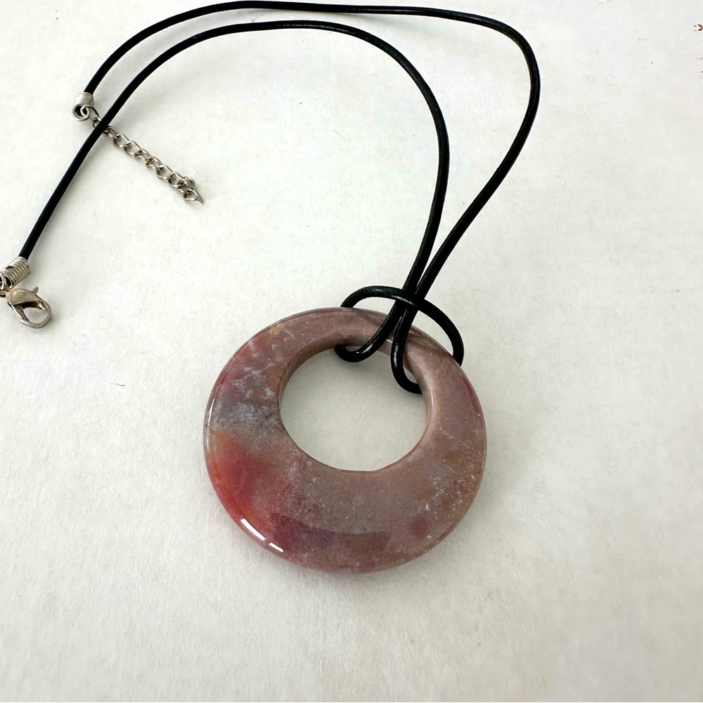 Natural stone pendant on the leather string with silver colored metal clasp